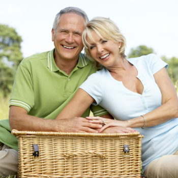 Mature couple having picnic in park