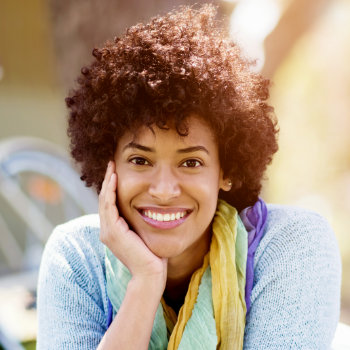 cheerful african american woman holding her cheek