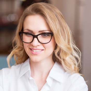 cheerful blonde woman in glasses smiling calmly
