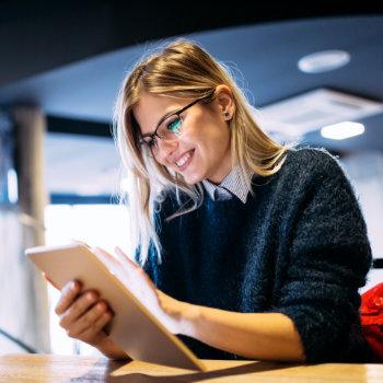 laughing businesswoman holding a tablet